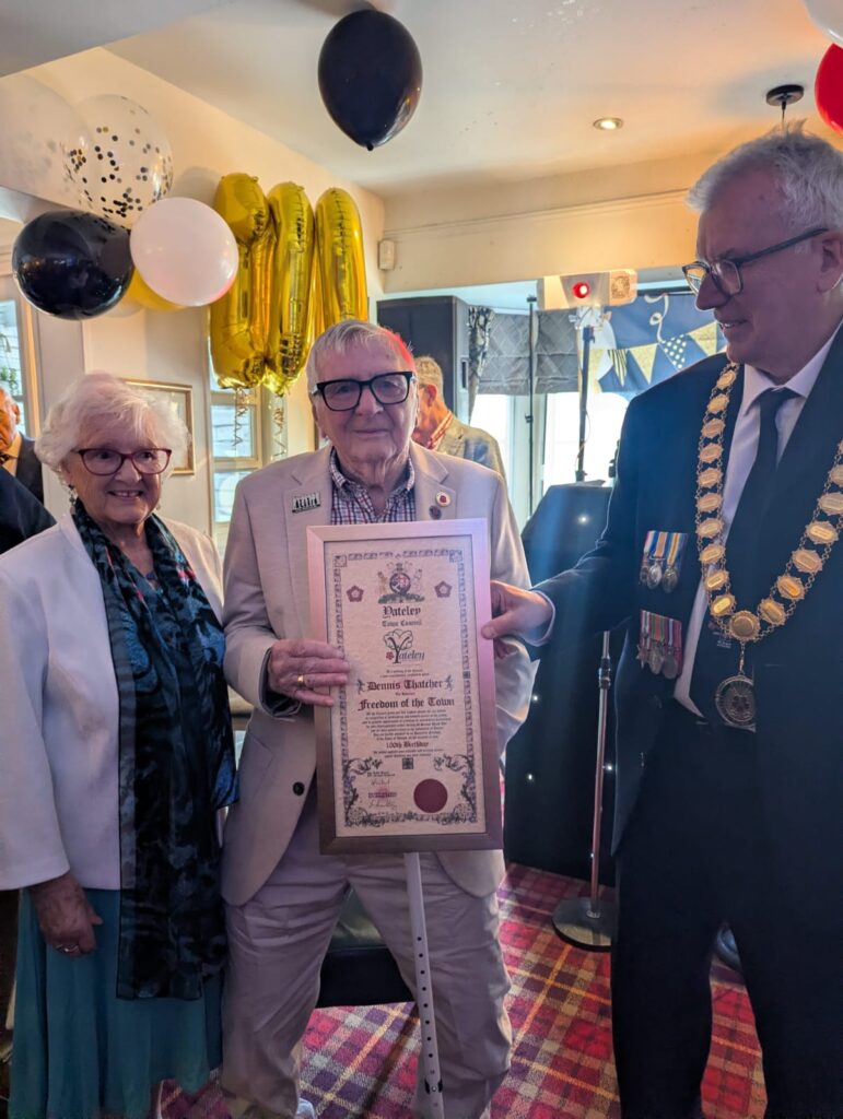 Dennis Thatcher, his partner, and Mark Griffin. Dennis is holding his Honorary Freedom of the Town certificate.